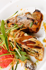Grilled pork steak with vegetable garnish.