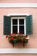 Fototapeta na wymiar Beautiful window with flower box and shutters
