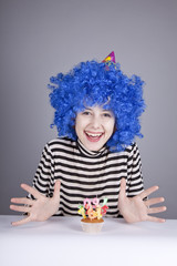 Funny blue-hair girl with cake.