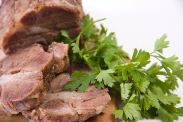 Appetizing piece of roasted meat on a wood piece with parsley