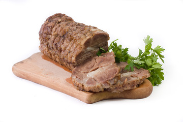 Appetizing piece of roasted meat on a wood piece with parsley
