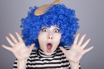 Surprised blue hair girl with stuck comb.