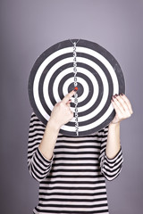 Girl with dartboard in place of head.