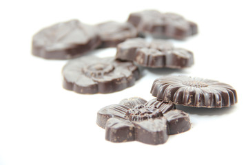Chocolates in the shape of flowers isolated on white