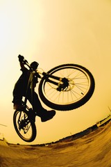 Silhouette Of A Cyclist Against A Yellow Sky