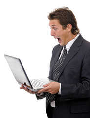 Young shocking businessman reading message on laptop