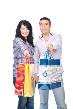 Happy shoppers couple give bags