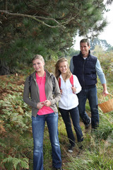 Parents and daughter walking in the countryside