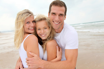 Fototapeta na wymiar Portrait of happy family at the beach