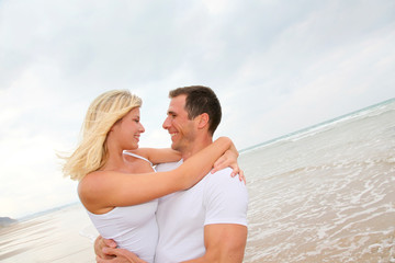 Happy couple enjoying vacation on a sandy beach