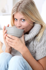 Beautiful woman drinking hot drink in winter