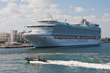 Sheriffs Boat Speeding Past a Luxury Cruise Ship