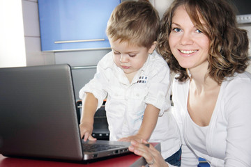 mother and son with laptop at home