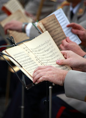People read notes on stand, and play music