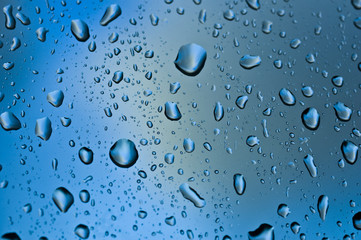 Rainy day droplets on cold window