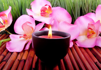Spa candle and  orchid flower for aromatherapy