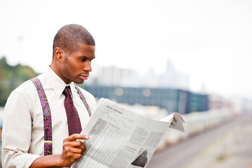 Businessman reading newspaper
