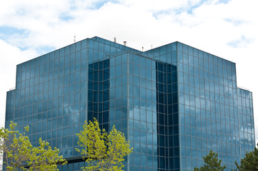 Modern Office Building with Trees and Clouds