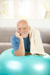 Portrait of active senior with fit ball