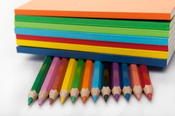 Fototapeta premium row of pencils under stack of books