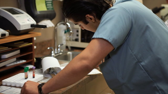 Doctor Nurse or Technician Working in Small Laboratory