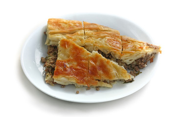 Puff pie stuffed with meat on a white background