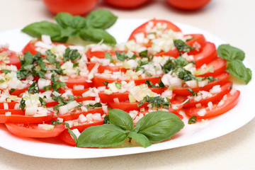 Salad from tomatos, onions, chive with basil