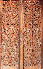 Thai art wood carving on door of temple