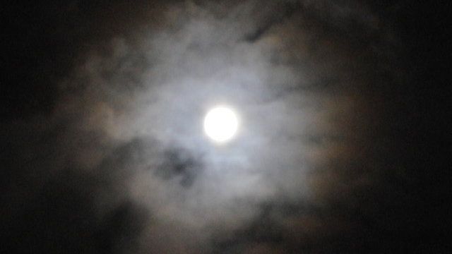 Moon at cloudy sky