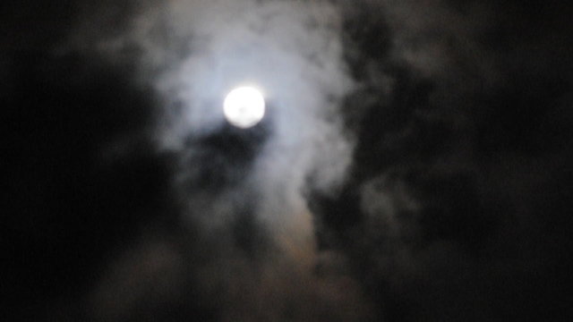 Moon at cloudy sky