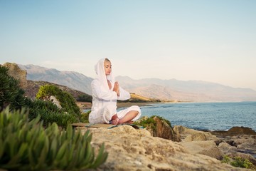 Fototapeta na wymiar Beautiful woman doing yoga exercise outdoors