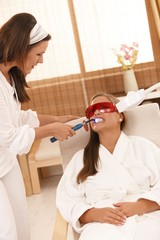 Woman getting tooth whitening