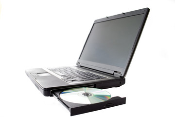Laptop with open drawer and disc.