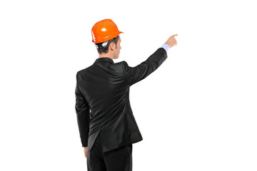 A view of a foreman in a suit pointing