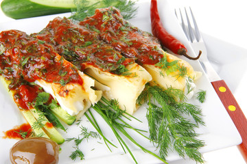 cannelloni with cheese on square white plate