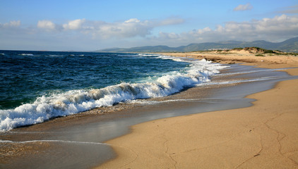 Fototapeta na wymiar Waves on the beach in island Sardinia, Italy.