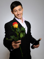 Handsome romantic young man holding rose flower and vine bottle - 27011474