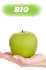 Green apple in a beautiful hand of woman with perfect nail manic