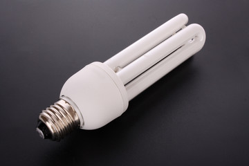 Energy saving light bulb on black