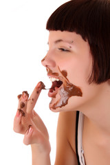 Young beautiful glutton eat chocolate isolated on white