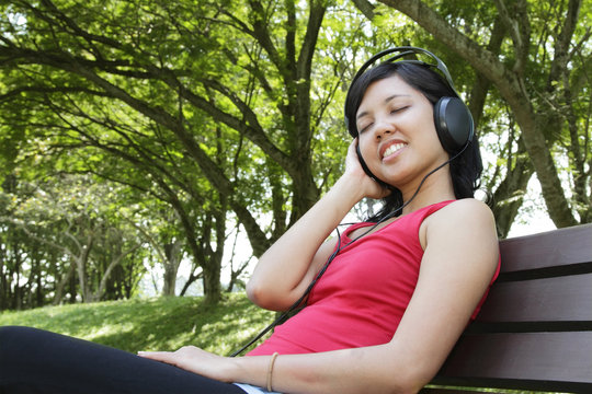 Woman listening to music at a park