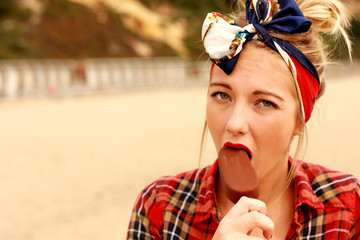 Fototapeta premium Young Woman Eating Ice Lolly. Model Released