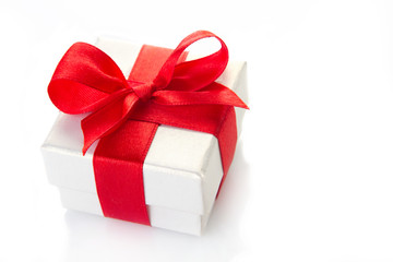 gift wrapped with a red ribbon on a white background