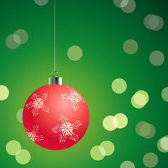Naklejka na ściany i meble Red christmas ball on the green background