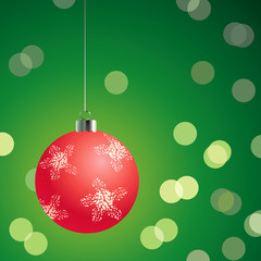 Red christmas ball on the green background