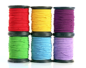 Coloured bobbins of thread isolated on white