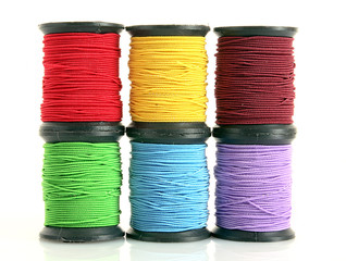 Coloured bobbins of thread isolated on white