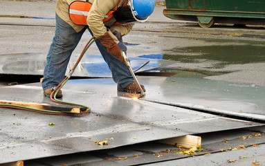 Worker with metal cutting torch