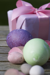 Easter eggs in pastel color with a gift in modern deco