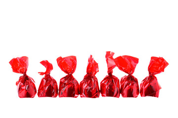 Red luxury sweets in a row isolated on white